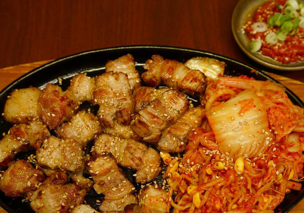 Grilled Pork Belly · Grilled pork belly, kimchi, vegetables on a hot iron plate