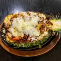 Piña Loca · Combination of Steak, Chicken and Shrimp, all served in 1/2 Pineapple, topped with shredded ...