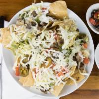 Nachos Platter · Fresh chips smothered in our white queso and covered with our choice of shredded chicken, ca...