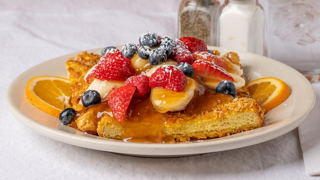 Crunchy French Toast · Dipped in Our Crunchy Batter & Grilled Golden Brown, Served with Carmelized Bananas and Fresh Berries