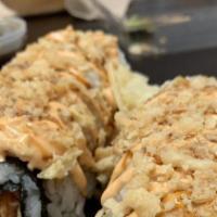 Spicy Crab Rangoon Roll · Spicy Crab, green onions, cream cheese and topped with eel sauce, Boss sauce and fried onions.