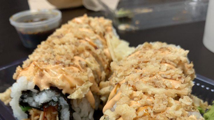 Spicy Crab Rangoon Roll · Spicy Crab, green onions, cream cheese and topped with eel sauce, Boss sauce and fried onions.