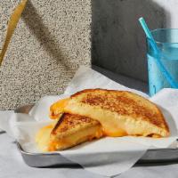 The Grown Up · Melted American and Pepper-Jack cheese grilled between two slices of buttered Texas toast.