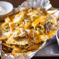 Nachos · Tortilla chips covered in a cheese blend, grilled chicken, beans, jalapenos and sour cream- ...