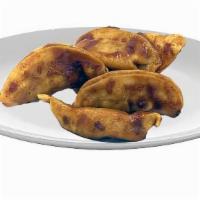 Sauced Pork Pot Stickers · 5 juicy pork pot stickers perfectly sauced and ready to eat.