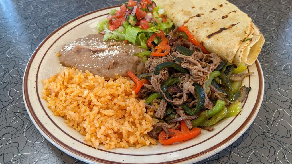 Machaca (House Specialty) · Braised and shredded beef refried with bell peppers, onions, and poblanos. Served with house-made corn tortillas, rice & beans, guacamole, and pico de gallo.