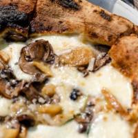 Funghi Pie · A white pizza with fresh mozzarella, porcini & cremini mushrooms, fresh basil & shaved parme...