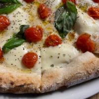 Caprese Pizza · A white pizza with fresh mozzarella, cherry tomatoes, fresh basil, oregano & extra virgin ol...