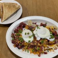 Corned Beef Hash* · Two eggs*(any style), scallions, cheddar cheese.