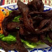 Thai Beef Jerky · Beef strips marinated in Thai spices and herbs, grilled and lightly fried, served with hot c...