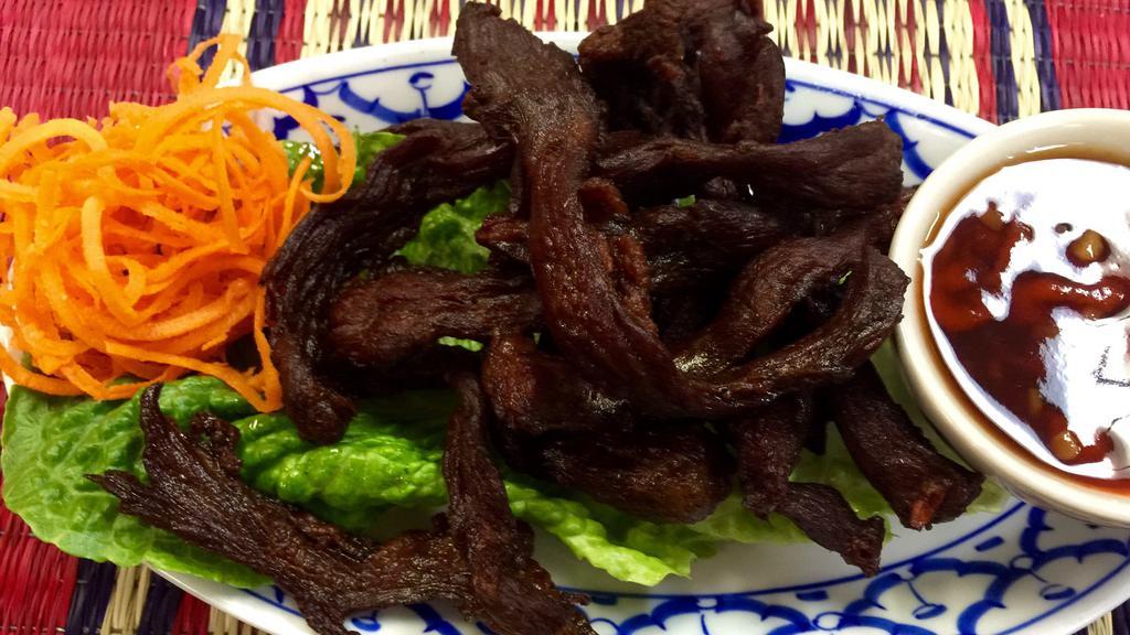 Thai Beef Jerky · Beef strips marinated in Thai spices and herbs, grilled and lightly fried, served with hot chili sauce.