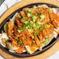 Volcano Chicken · Seasoned, lightly battered chicken served on a bed of cabbage and carrot topped with special...
