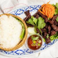 Beef Jerky And Sticky Rice · Beef strips marinated in Thai spices and herbs, grilled and lightly fried, served with hot c...