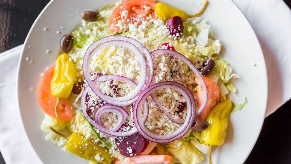 Greek Salad · A fresh crisp taste of the greek islands; mixed greens, tomato wedges, feta cheese, beets, onions, olives and peppers. Served with pita and your choice of dressing.