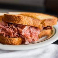 Corned Beef · Lean sliced corned beef with swiss cheese on light rye.