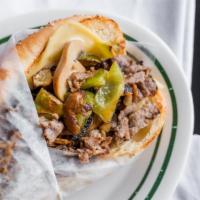 Philly Sub · Thin slices of tender beef steak with grilled mushrooms, onions and green peppers with Swiss...