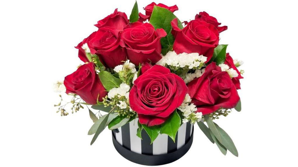 Red Roses, White Statis, & Eucalyptus Flower Box · A flower box featuring 12 red roses, white statis, and eucalyptus.