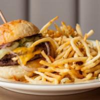 Dilly Burger · Double meat, double cheese, shaved red onion, house sweet pickles, and fancy sauce on a pota...