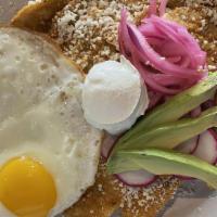 Chilaquiles · Tortilla chips, roasted tomato salsa, two eggs, Cotija cheese, pickled onions, sour cream, a...