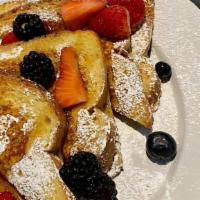 Classic French Toast · Brioche bread dipped in special batter. Topped with butter and powdered sugar.