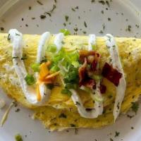 Loaded Potato Omelet · Bacon, onions, roasted potatoes, and sharp Cheddar cheese. Topped with sour cream and chives...