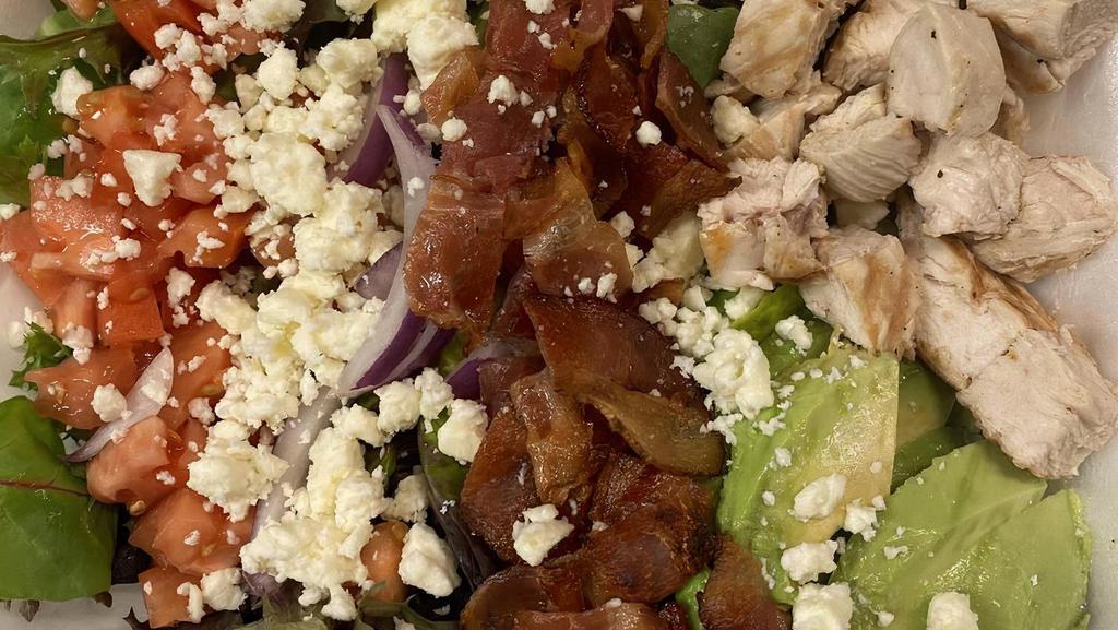Cobb Salad · Spring mix, grilled chicken, hard boiled egg, bacon, tomatoes, onions, avocado, feta cheese and ranch.