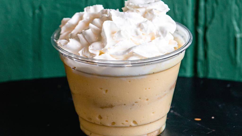 Banana Pudding · Classic vanilla pudding layered with vanilla cookie and sliced banana. Topped with whipped cream.