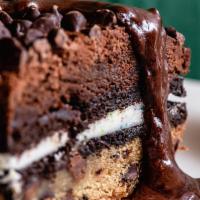 The Slutty Brownie · Layered with chocolate chip cookie dough, Oreo and fudge brownie topped with drizzled with c...
