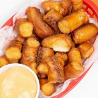 Fried Pretzel Bites · Pretzel bites served with beer cheese or mustard. both beer cheese and beer mustard add $1.25.