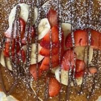 Nutella Pancakes · Topped with nutella, strawberries, and banana.