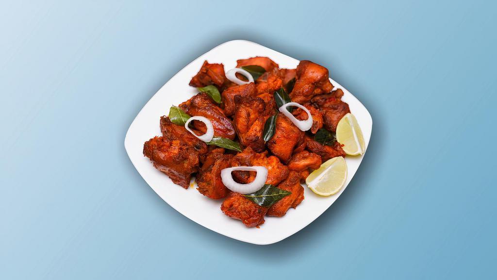 Kung Fu Chicken  · Succulent chicken morsels  marinated with ginger, garlic, chilies, yogurt,  batter fried and wok tossed with Indo Chinese sauces, garlic and curry leaves