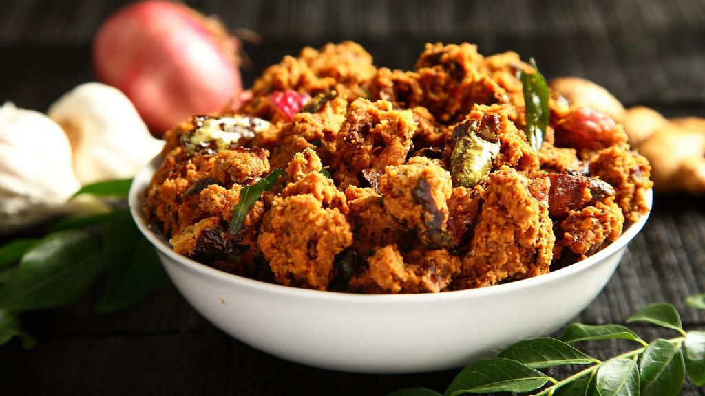 Vegetable Pakora · Thinly sliced onions and potatoes dipped in a spiced chickpea flour batter and fried.