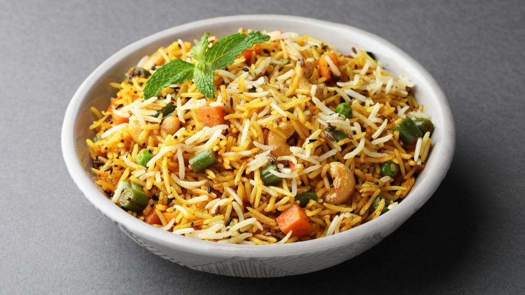 Vegetable Biryani · Basmati rice cooked in a spiced vegetable broth, with fresh veggies topped with cashews and cilantro.