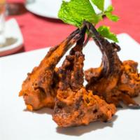 Lamb Tandoori · Tender lamb chops marinated in yogurt and fragrant spices, cooked in our hot tandoor and ser...
