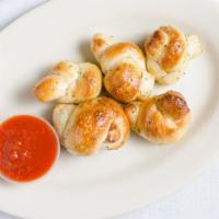 Garlic Knots (5 Pieces) · Hand-tied bread knots tossed in garlic butter, garlic salt, and parsley.