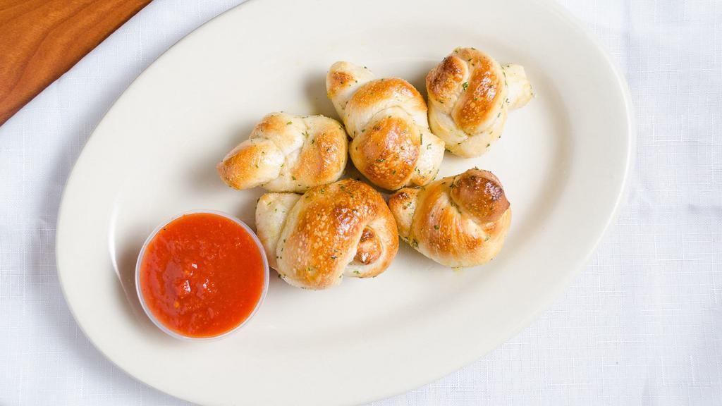 Garlic Knots (5 Pieces) · Hand-tied bread knots tossed in garlic butter, garlic salt, and parsley.
