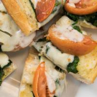 Spinach And Tomato Garlic Bread · Served with melted mozzarella.