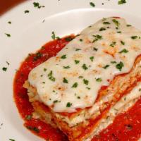 Baked Lasagna · Layers of ribbon noodles and 4 cheeses smothered in marinara sauce and mozzarella cheese. Se...