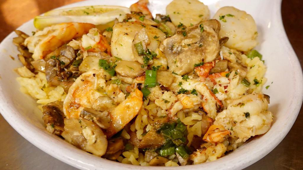 Seafood Saute' · Shrimp, scallops and crab, sauteed in garlic butter with mushrooms and green onions, served over rice pilaf.