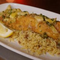 Grouper Piccata · Lightly dusted tender Grouper with a lemon butter, caper and artichoke sauce, over rice pilaf.