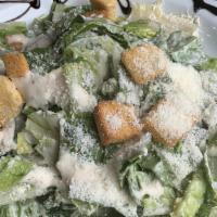 Caesar · Romaine lettuce, Parmesan cheese and homemade croutons in a caesar dressing.