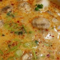 Tom Kha · A mild spicy coconut cream soup with white onion, mushroom, green onion and cilantro. Spicy.