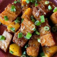 Maui Bacon · Fried pork belly, tossed with pineapple in a soy-honey sauce.  Garnished with scallions.