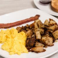 One Egg · One sausage link or one bacon strip, crispy seasoned potatoes, one slice of toast and a beve...