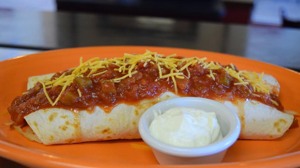 Tex Mex · Hash browns mixed with spicy andouille sausage, topped with two scrambled eggs and cheese then wrapped in a warm flour tortilla topped with salsa and sprinkled with cheddar cheese served with sour cream.