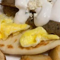 Greek Breakfast · Toasted pita, tzatziki, gyro, topped with two scrambled eggs and feta cheese. Served with br...