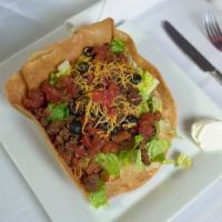 Taco Salad · Chicken or Beef, Black olives, tomatoes, onions, sour cream and salsa in our homemade taco s...