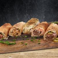 Chicken Shawarma · Chicken shawarma rolled in a pita with garlic sauce and pickles.