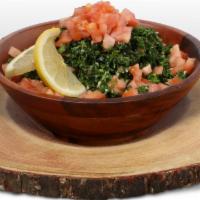 Tabbouli Salad · Vegetarian. Fresh curly parsley with chopped tomatoes and onions, dry mint, cracked wheat, s...