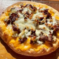 Cheesesteak · Griddled Steak, Sautéed Onions, Sweet Pepper Strips, and Mushrooms over a Cheese Wiz Base To...